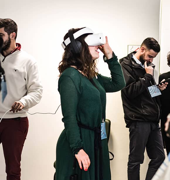 femme équipée d'un casque de réalité virtuelle explorant un jeu virtuel lors d'une soirée événementielle